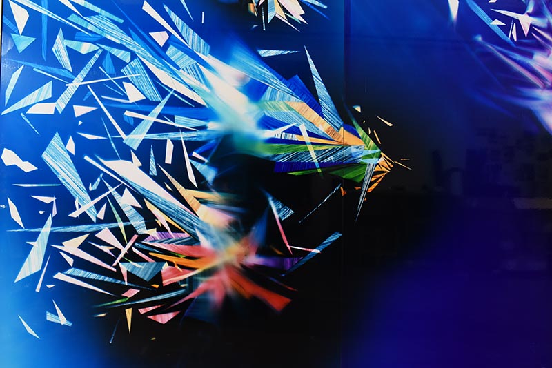 A detail close-up of the mural-scale color photogram titled, Precariously Bright
